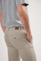 Sustainable MUD Jeans crafted from organic cotton in classic white, paired with a blue denim shirt for an ethical look.