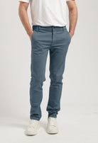 Sustainable MUD Jeans in white denim, classic fit, paired with a dark blue denim shirt, emphasizing ethical fashion.