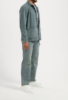 Sustainable MUD Jeans made from organic cotton, featuring mid-blue denim in a slim fit, paired with a white t-shirt.