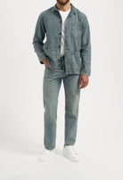Sustainable MUD Jeans in light blue denim, ethical fashion choice, paired with a white t-shirt, back view.