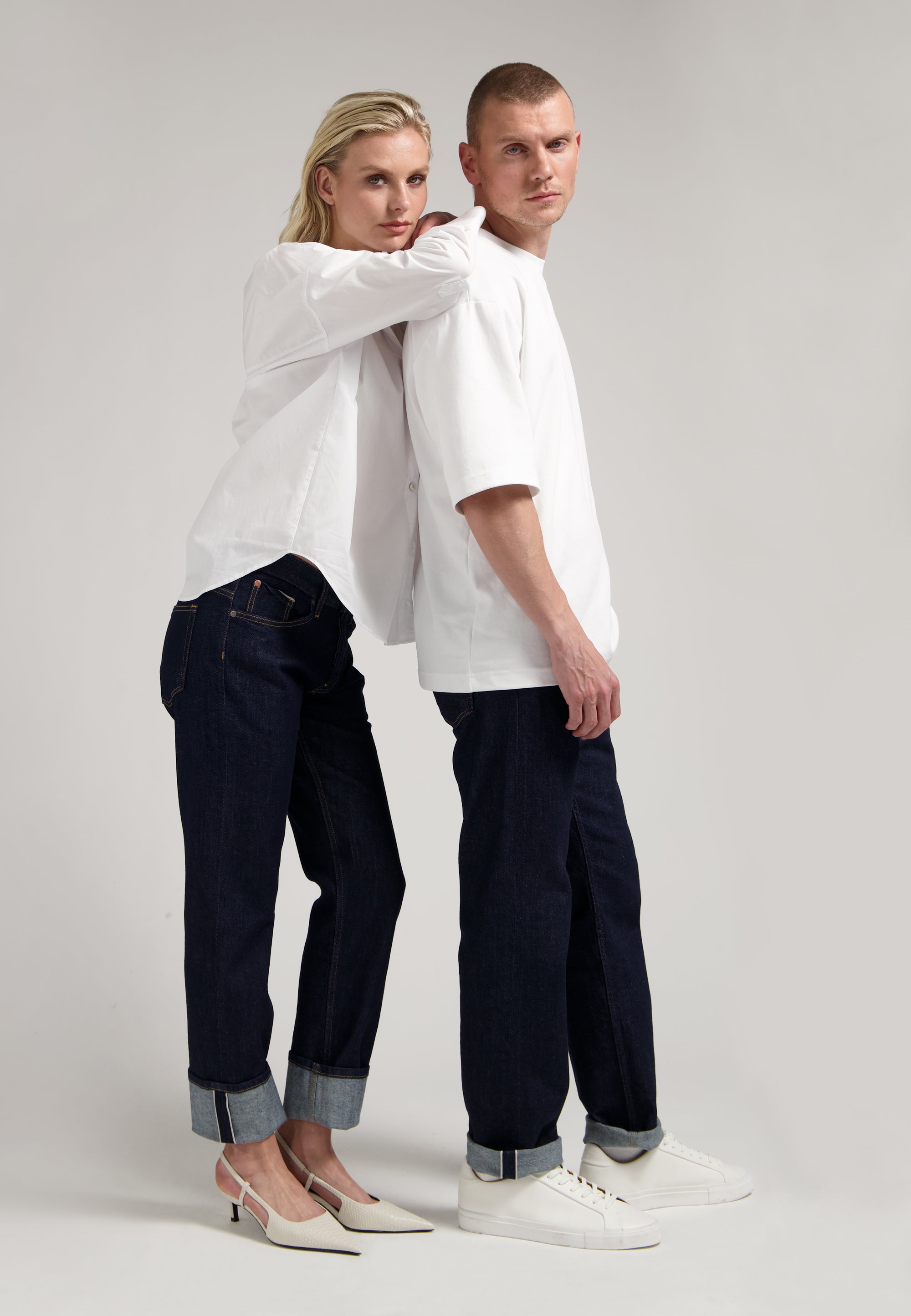Sustainable MUD Jeans in blue denim, featuring ethical production and eco-friendly materials, paired with a gray sweater.