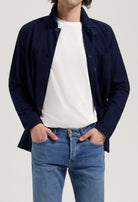 Sustainable MUD Jeans made from organic cotton, classic blue denim paired with a white tee and sneakers.