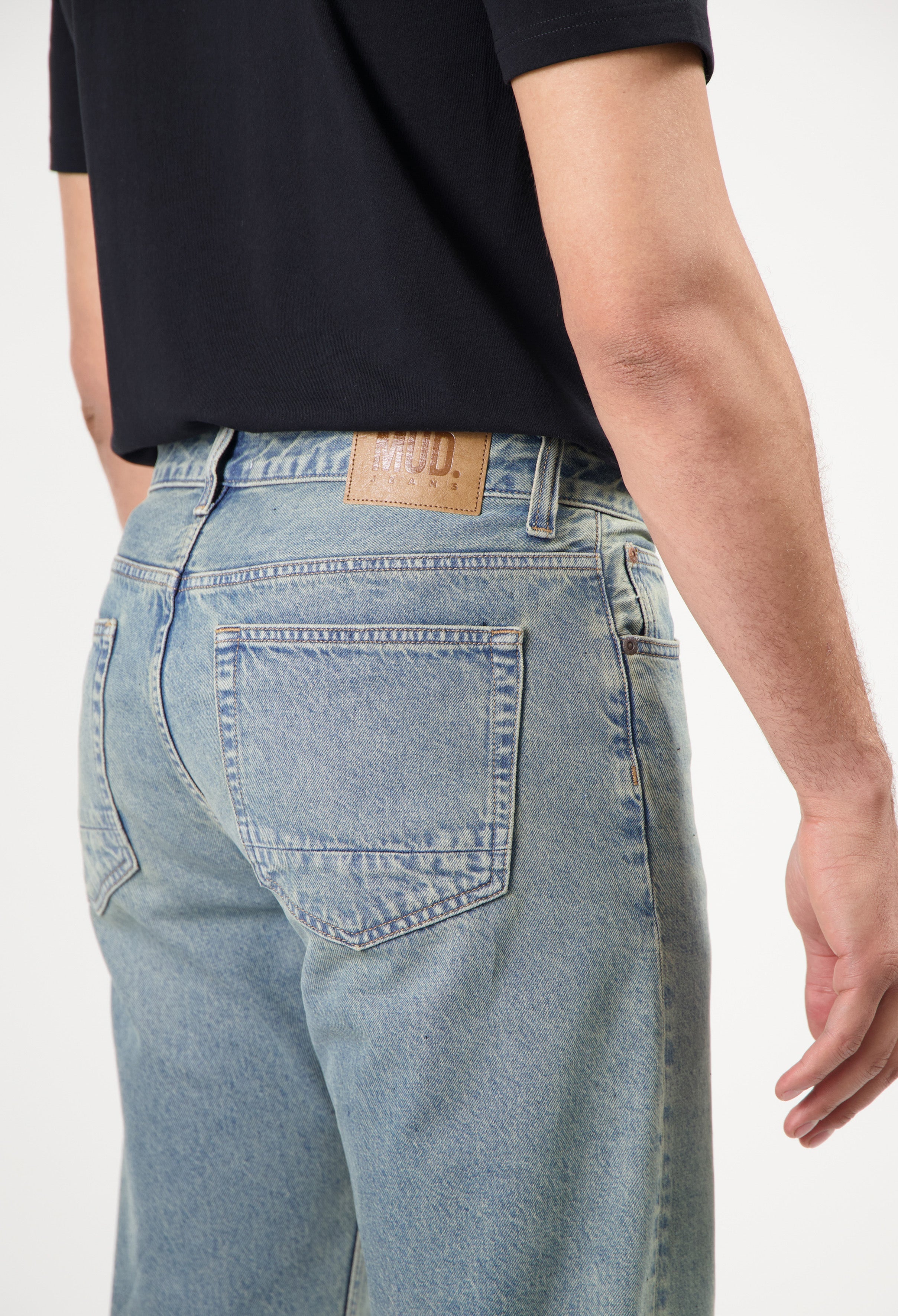 Sustainable MUD Jeans in black denim, featuring a slim fit design, crafted with ethical production methods.