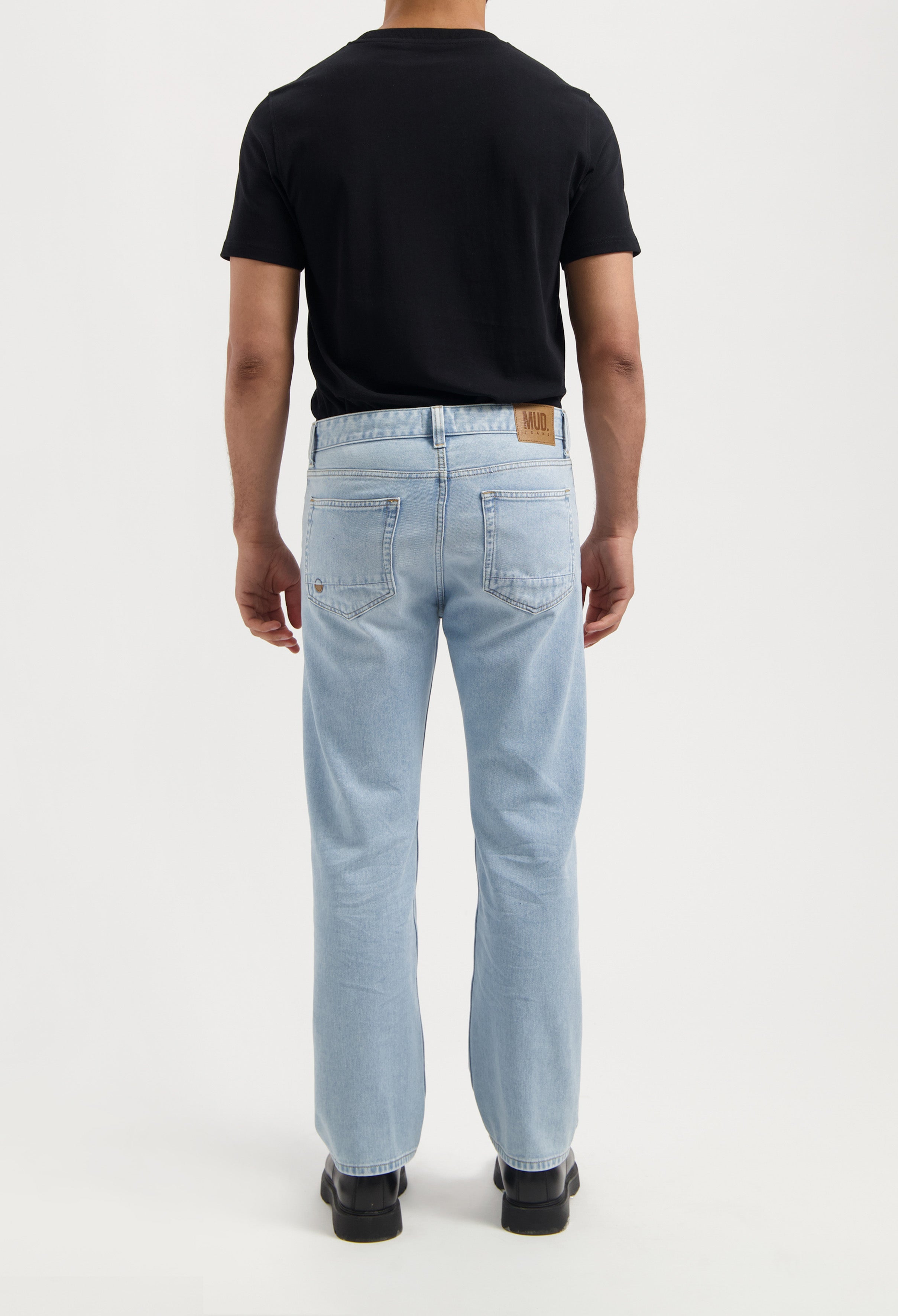 Sustainable MUD Jeans in black, made from organic cotton, featuring a sleek, ethical design in a slim fit.