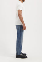 Sustainable MUD Jeans in light blue denim, crafted from organic cotton, showcasing ethical fashion with classic stitching.