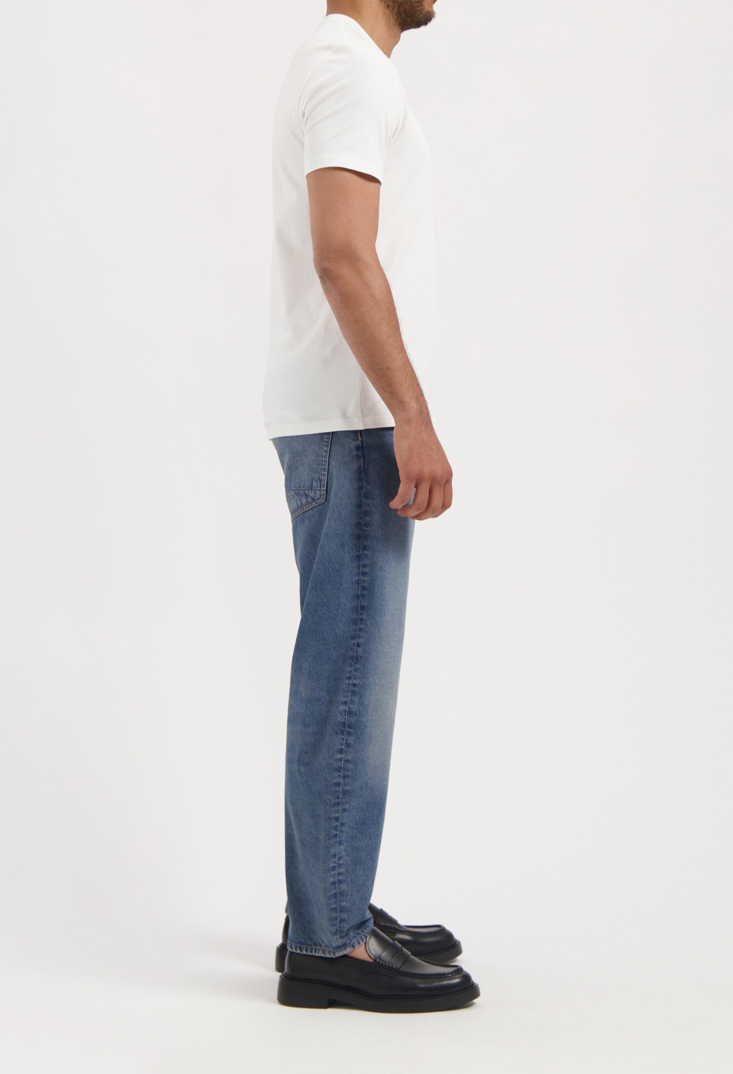 Sustainable MUD Jeans in light blue denim, crafted from organic cotton, showcasing ethical fashion with classic stitching.