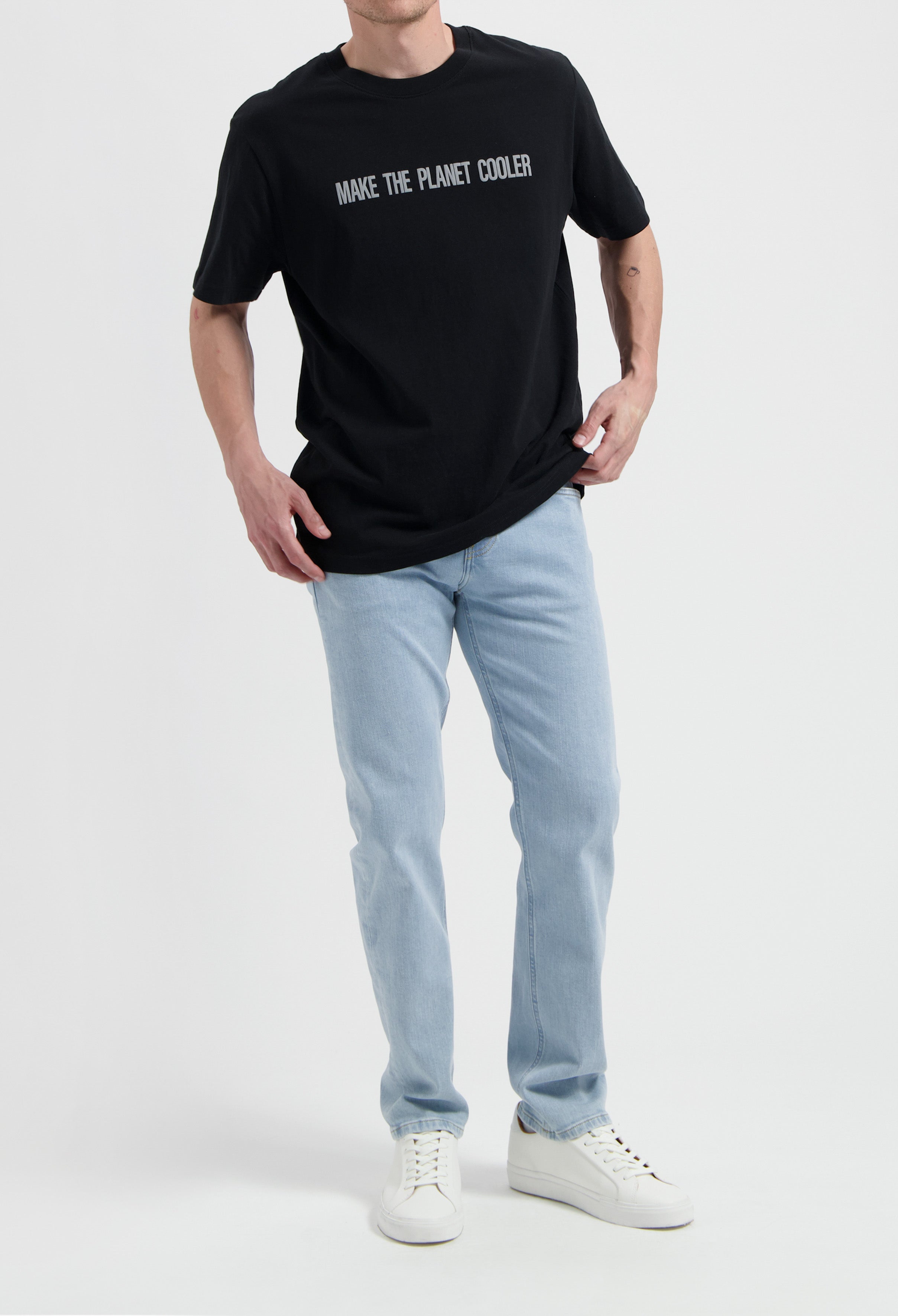 Sustainable MUD Jeans in deep blue denim, ethical and crafted from organic cotton, paired with a classic white t-shirt.