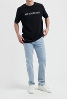 Sustainable MUD Jeans in deep blue denim, ethical and crafted from organic cotton, paired with a classic white t-shirt.