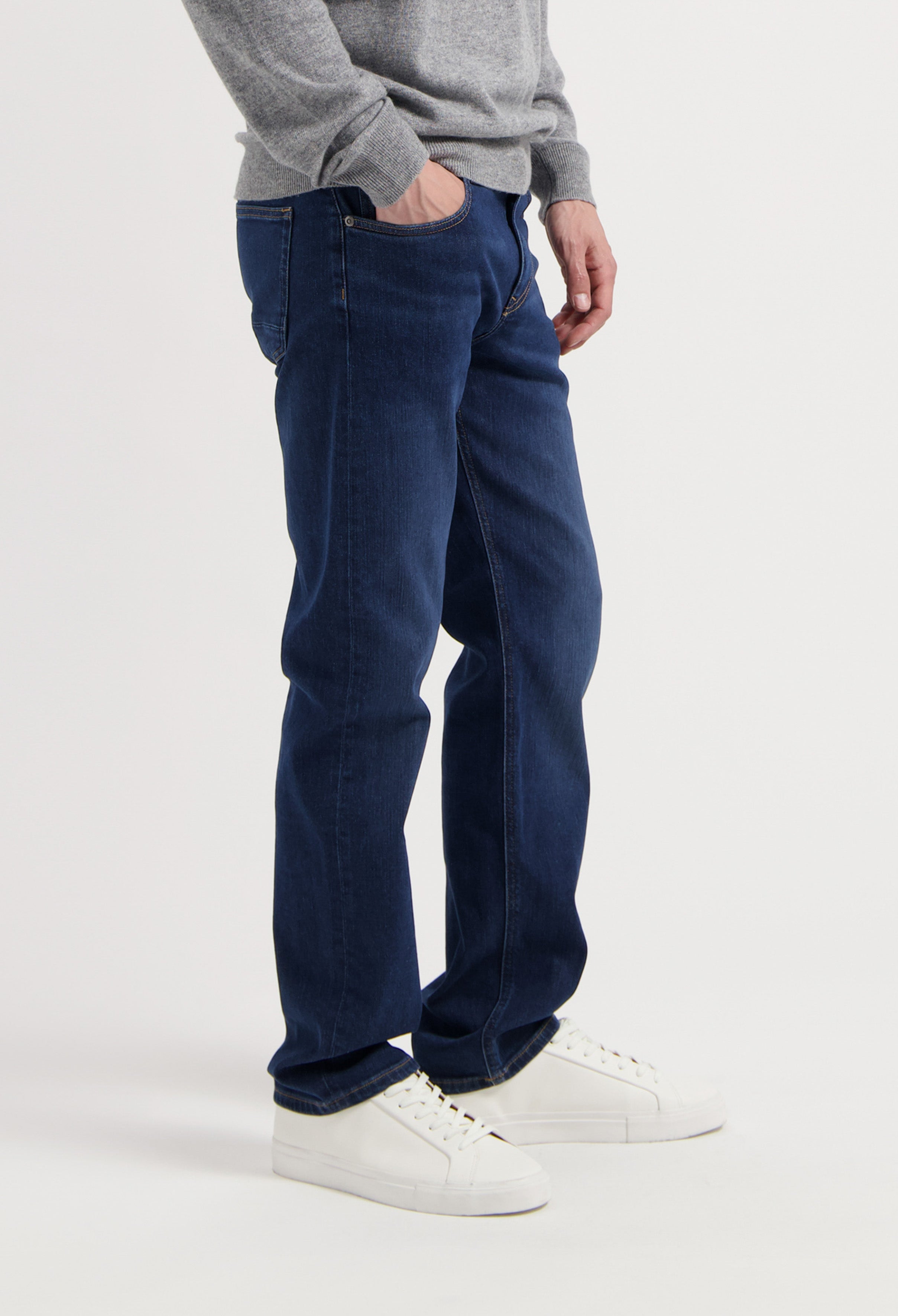 Sustainable MUD Jeans in a classic blue wash, featuring a matching jacket, highlighting ethical fashion and style.