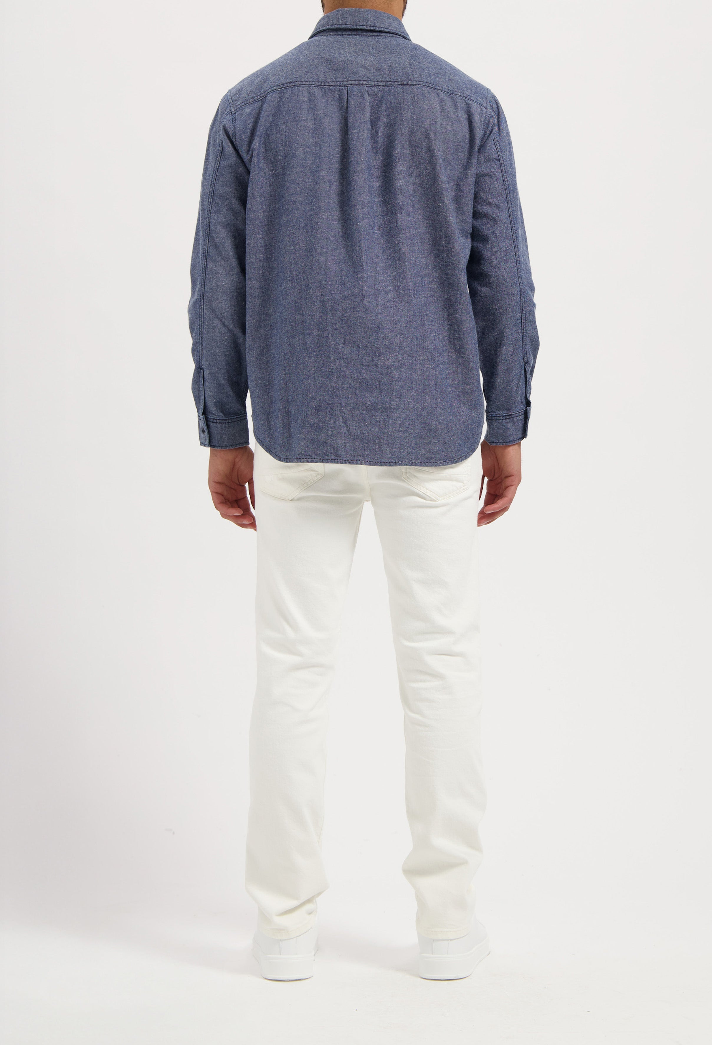 Sustainable MUD Jeans shorts crafted from ethical denim, featuring light blue fabric, paired with a white t-shirt.