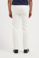 Sustainable MUD Jeans in deep blue denim, relaxed fit, worn with a black t-shirt and white sneakers for an ethical style.