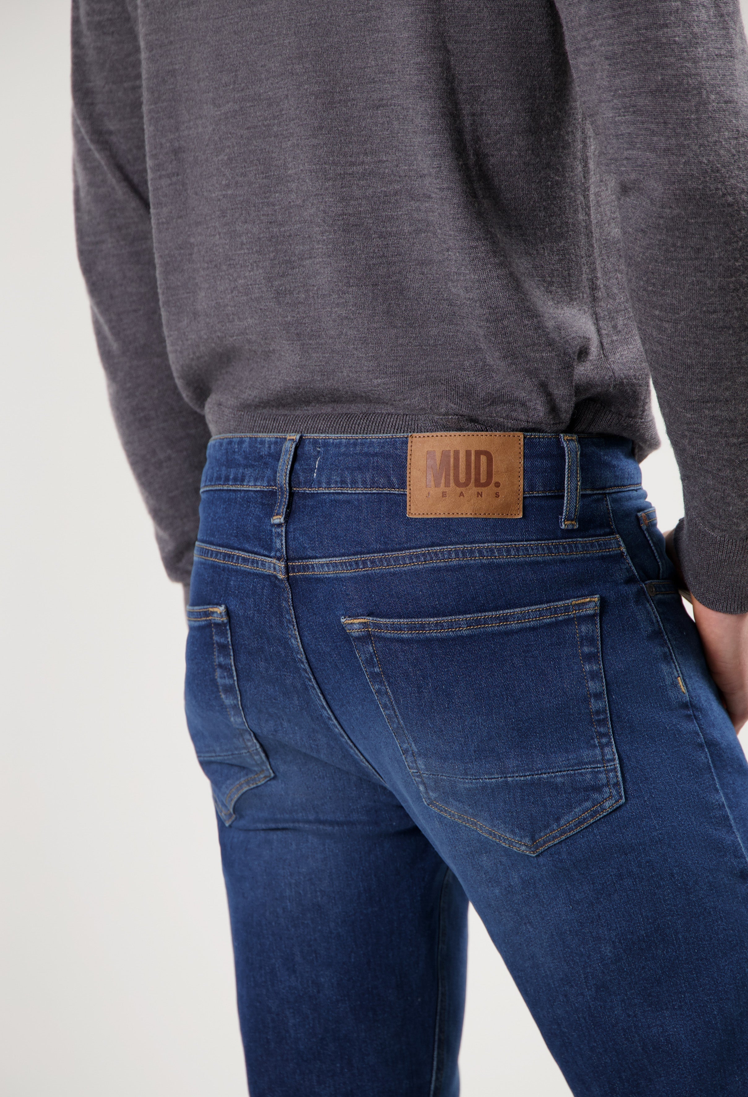 Sustainable MUD Jeans crafted from eco-friendly materials, featuring deep blue denim and a comfortable fit.