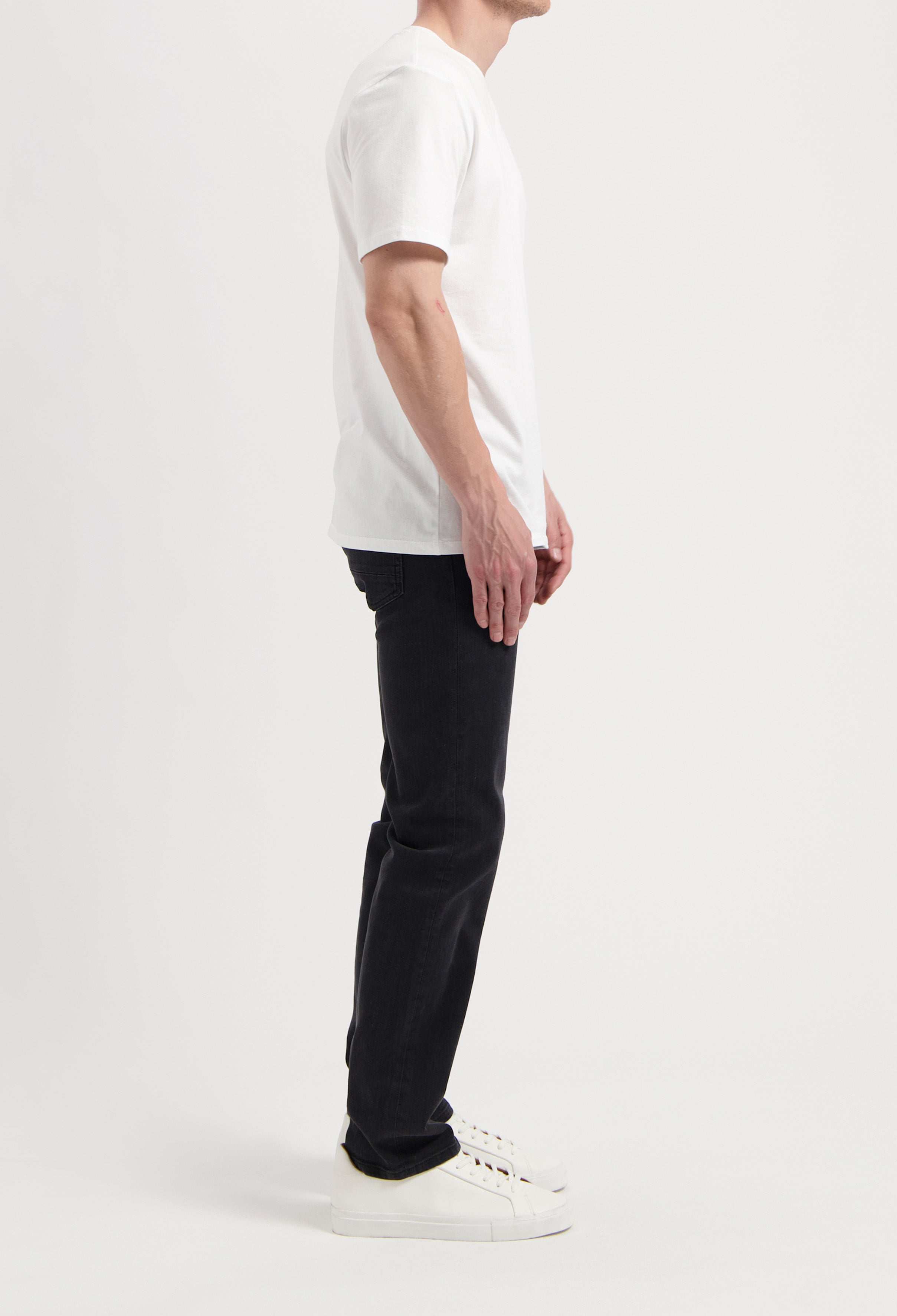 Sustainable MUD Jeans made from organic denim, featuring a relaxed fit in blue, paired with a classic white T-shirt.