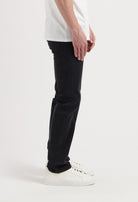 Sustainable MUD Jeans in classic blue denim, ethically made, shown in a relaxed fit, paired with a white tee.