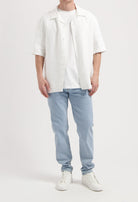 Sustainable MUD Jeans in indigo denim, featuring a classic pocket design, emphasizing ethical craftsmanship and style.