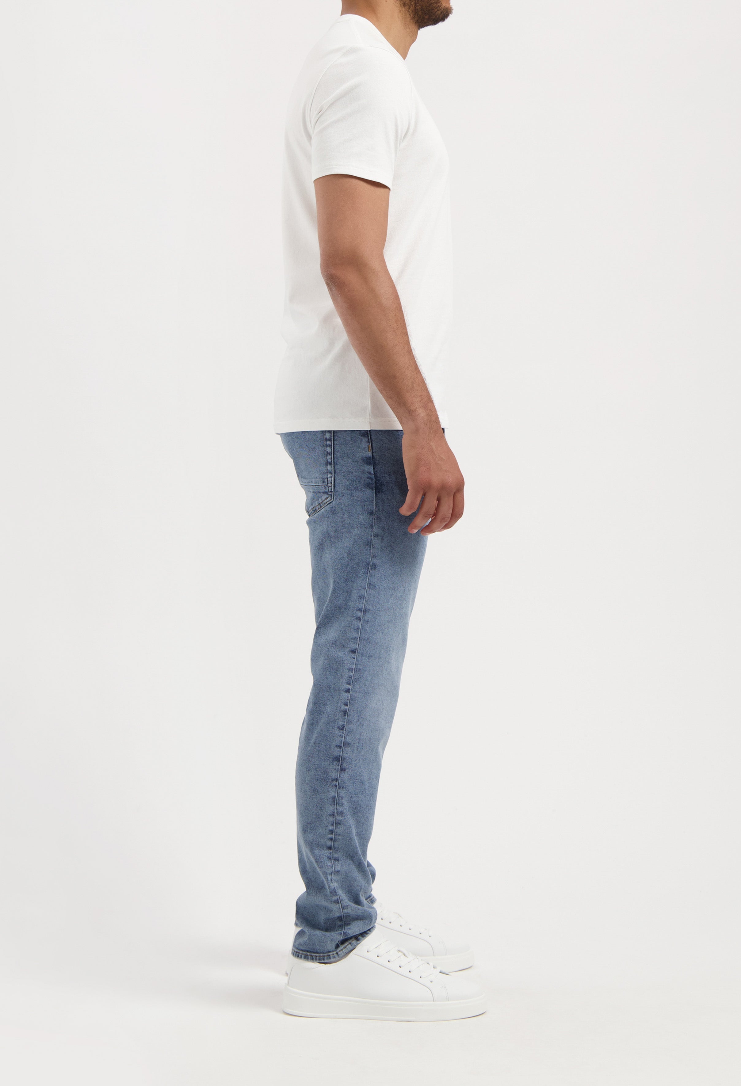 Sustainable Mud Jeans blue shorts, crafted from organic cotton, paired with a black tee, showcasing ethical fashion.