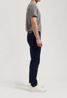 Sustainable black denim MUD Jeans with ethical production, paired with a cozy gray sweater for an eco-friendly style.