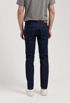 Sustainable MUD Jeans in dark denim paired with a cozy gray sweater, showcasing ethical fashion for modern style.