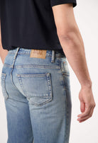 Sustainable MUD Jeans navy t-shirt paired with matching shorts, showcasing ethical fashion with white sneakers.