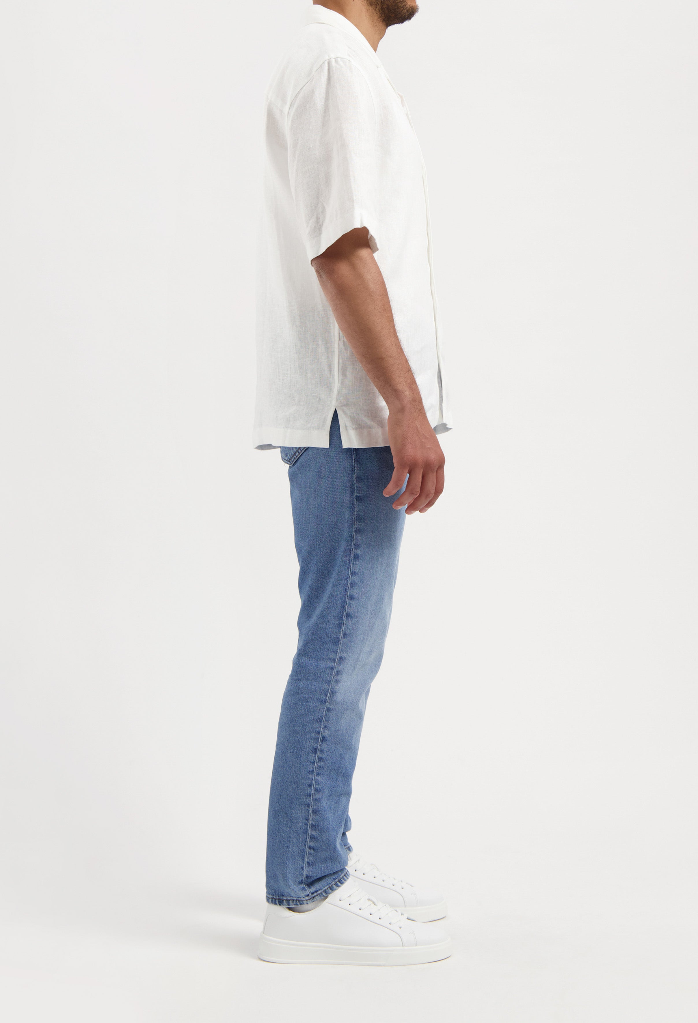 Sustainable MUD Jeans navy shorts in organic cotton, highlighting classic fit and ethical fashion focus.