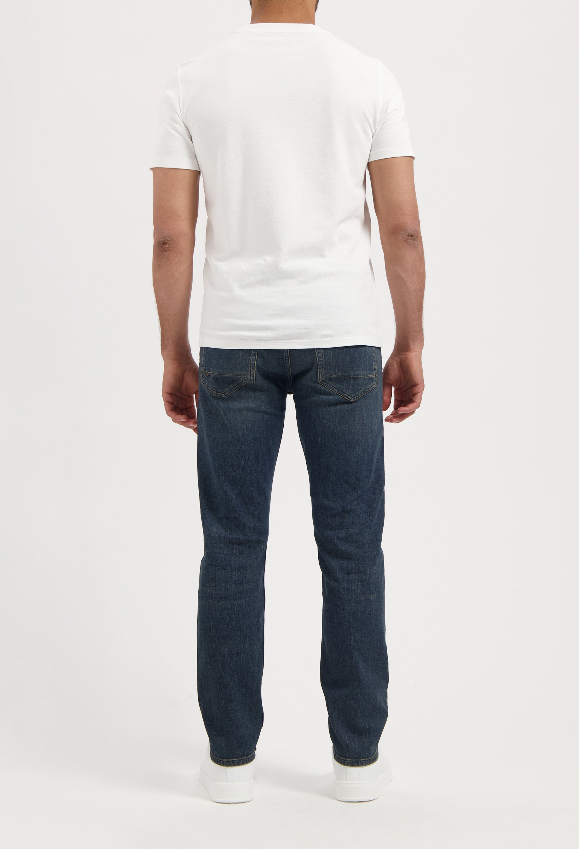 Sustainable MUD Jeans in light blue denim, classic fit, paired with a black t-shirt. Eco-friendly fashion choice.