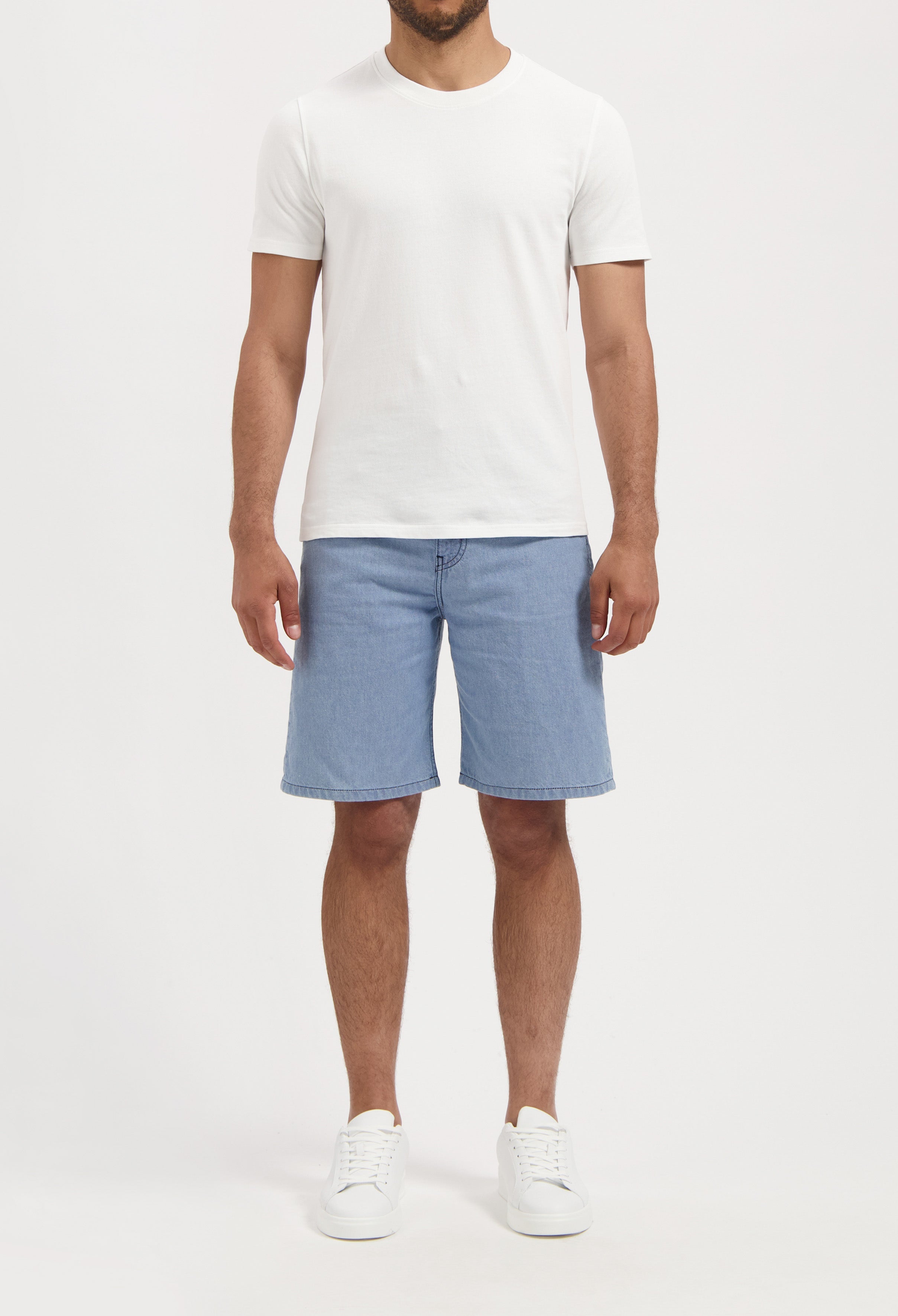 Sustainable MUD Jeans in classic black denim, crafted for ethical fashion, paired with a cozy gray sweater.