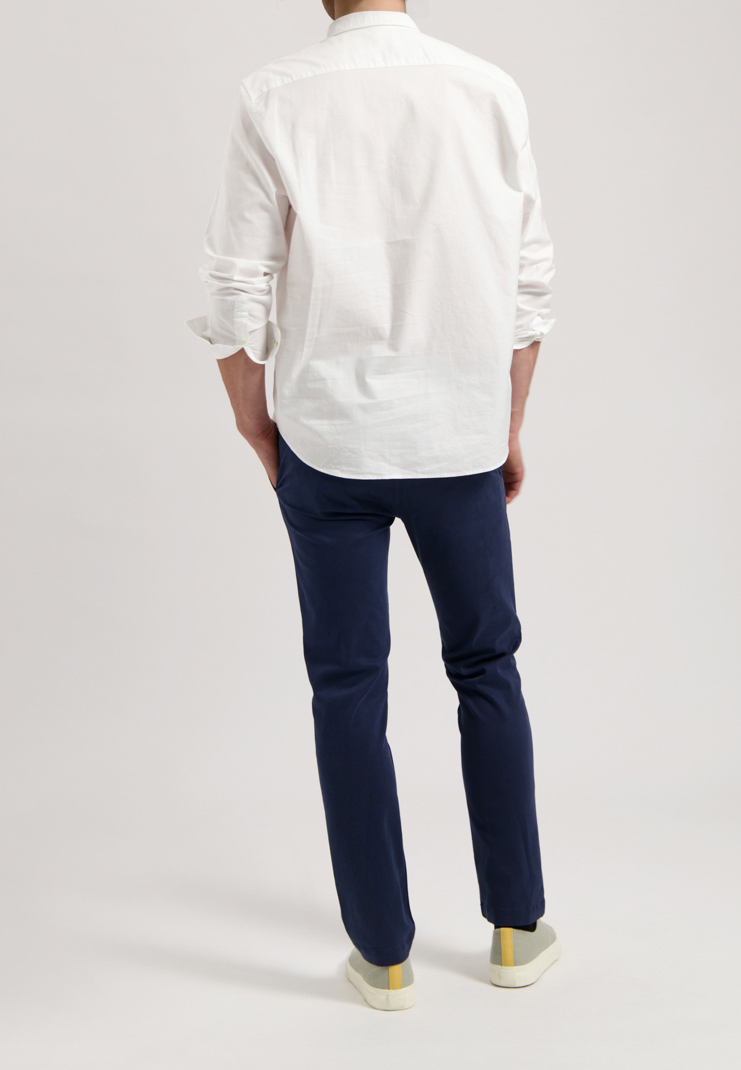 Sustainable MUD Jeans in gray denim, featuring a straight fit, paired with a black shirt, highlighting ethical fashion.