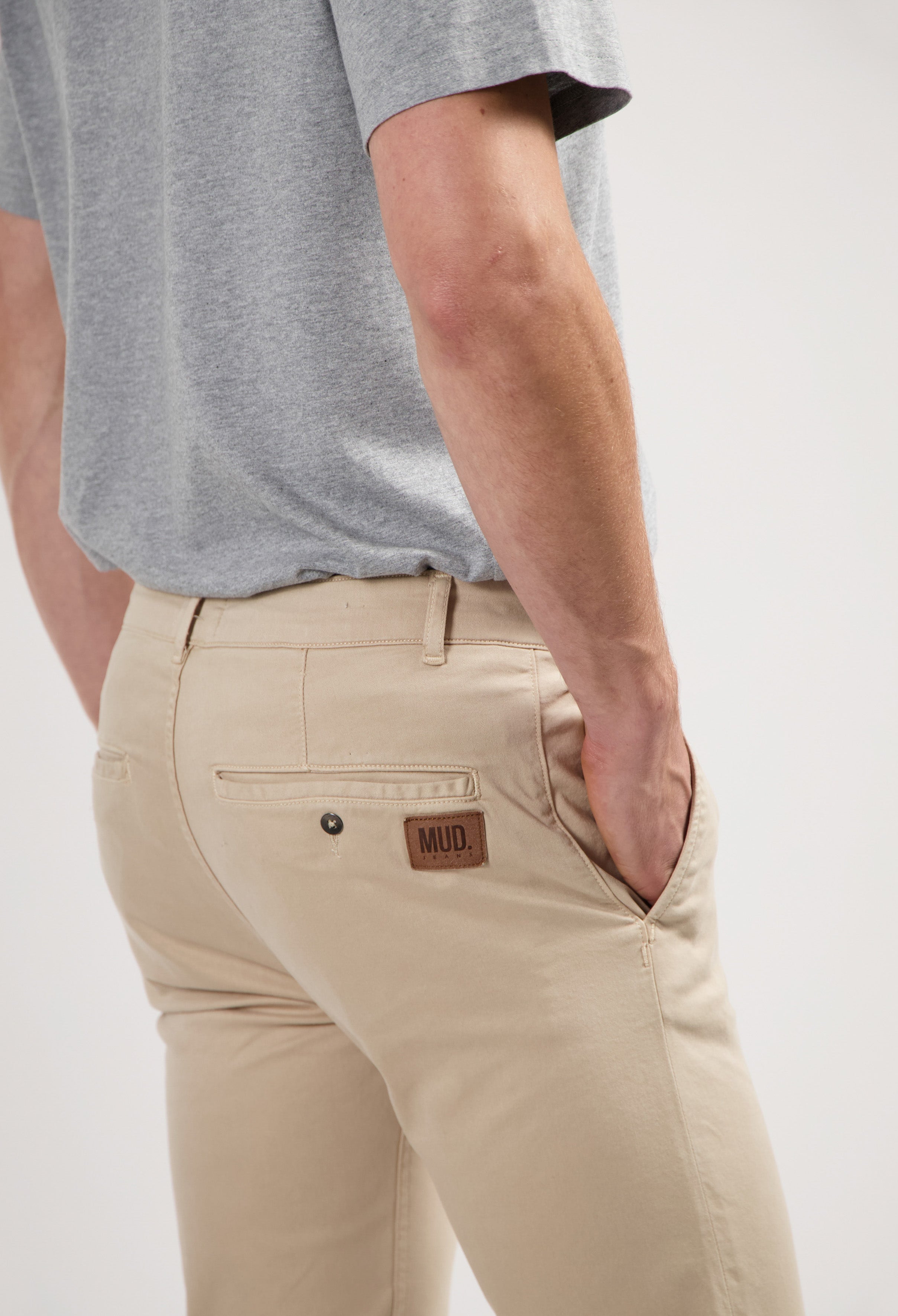 Sustainable MUD Jeans made from organic cotton, featuring blue denim with a classic fit, paired with a dark gray sweater.