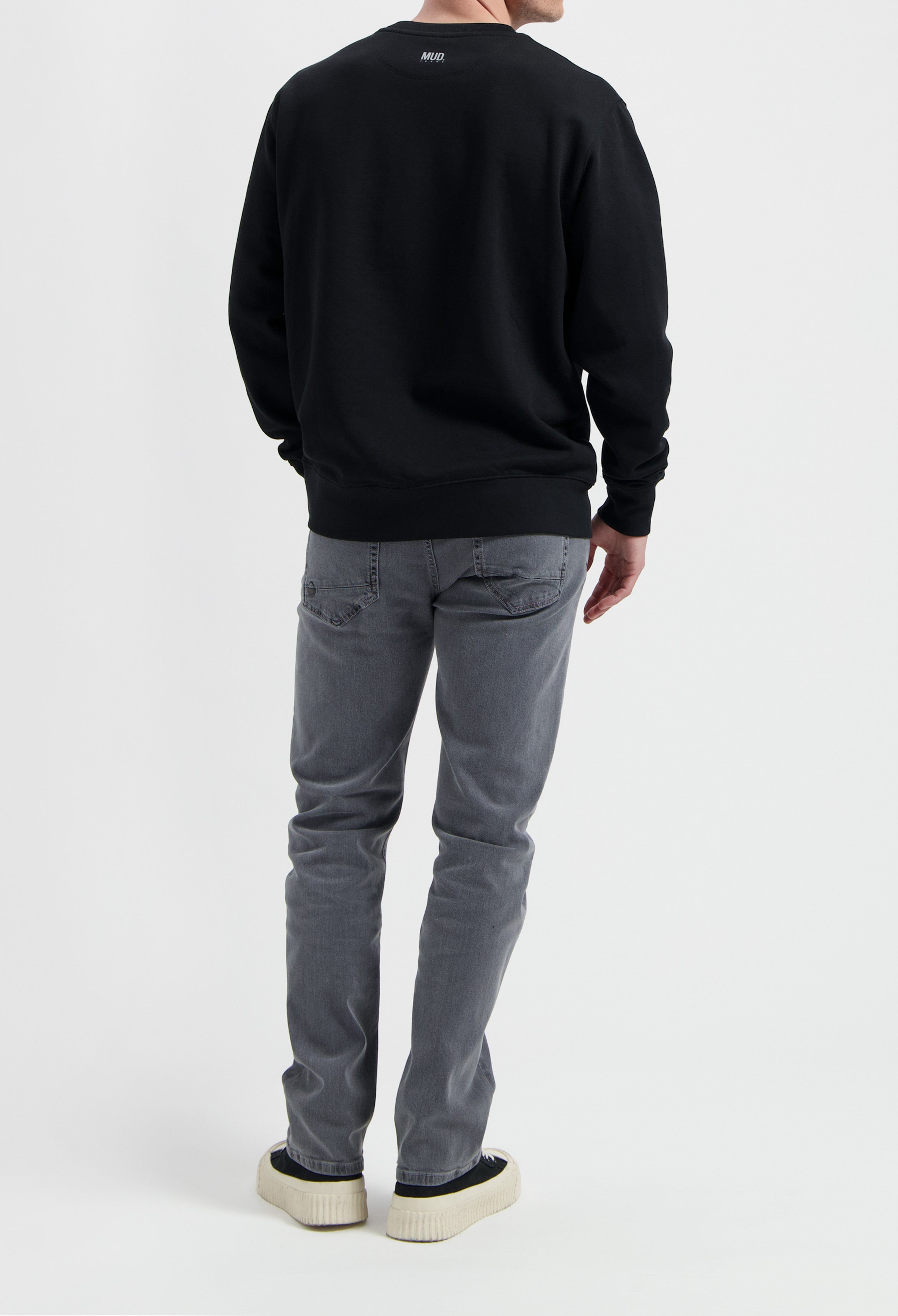 Sustainable MUD Jeans in light blue denim, crafted with organic cotton, showcasing ethical fashion with a classic fit.