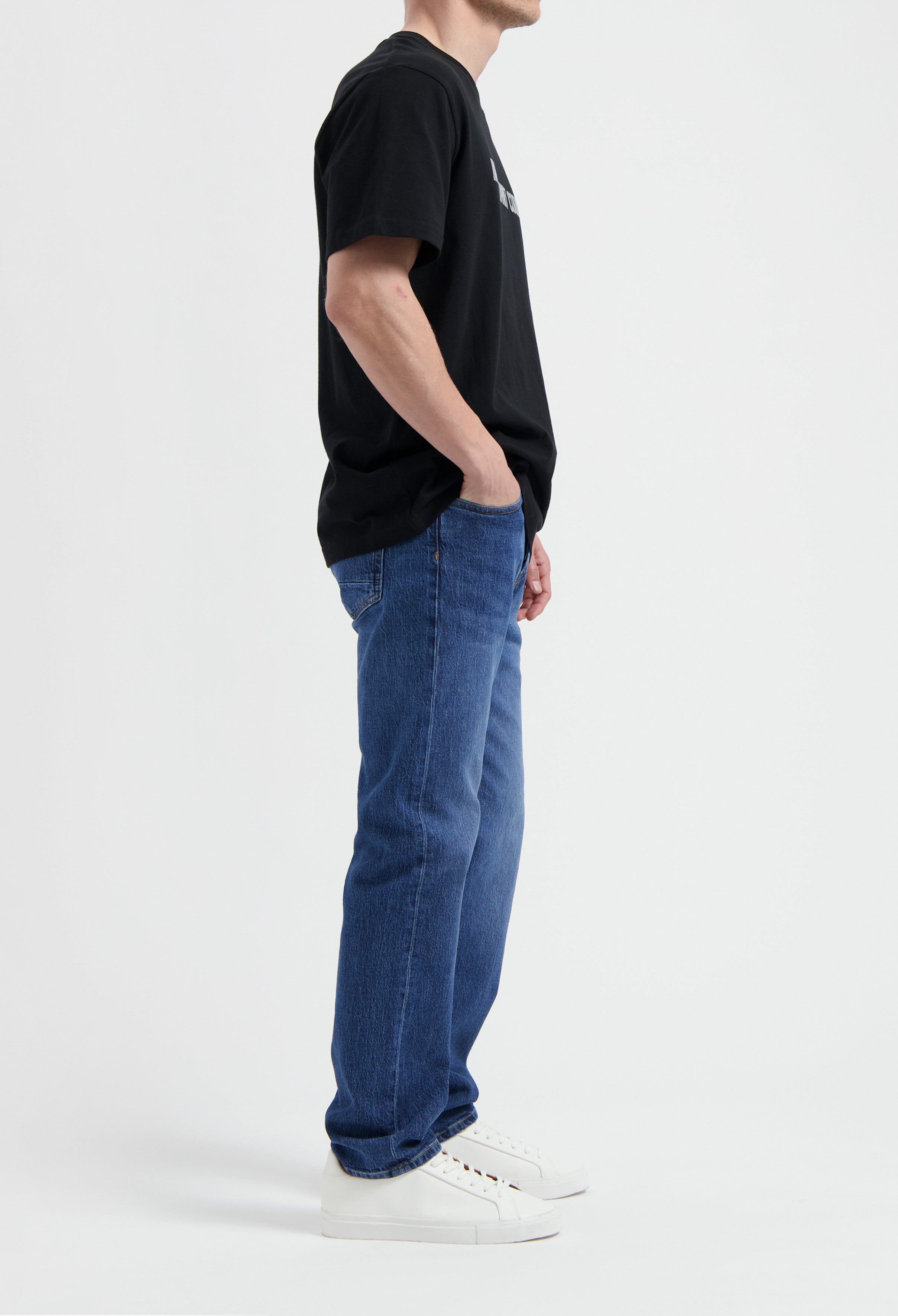 Sustainable MUD Jeans in dark brown, crafted from organic cotton, showcasing ethical fashion with a tapered fit.