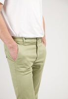 Sustainable MUD Jeans in light blue denim, designed for a classic fit, paired with a white ribbed sweater.