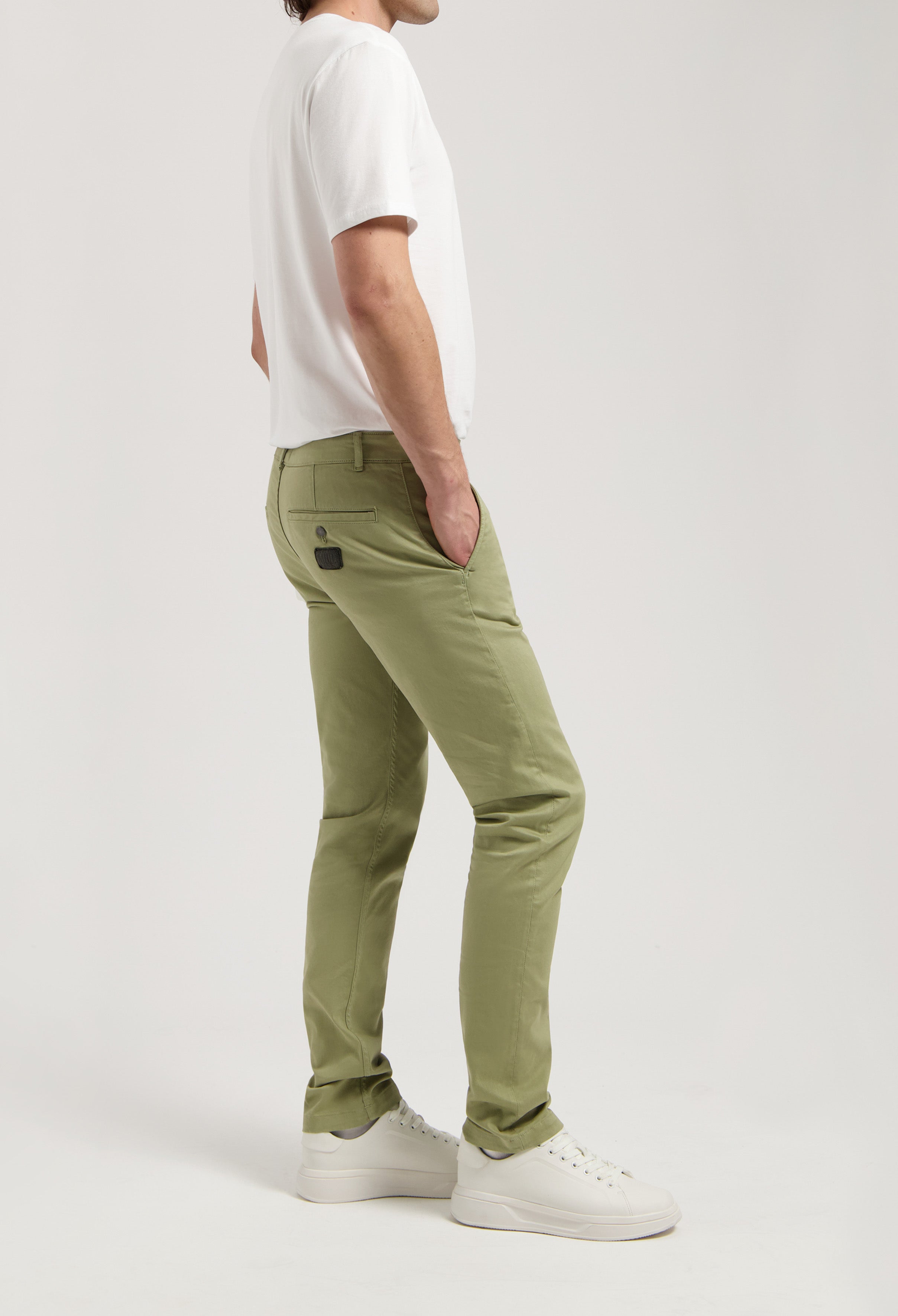 Sustainable MUD Jeans in dark denim, showcasing ethical fashion with a minimalist design, styled with casual footwear.