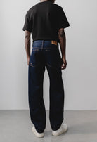 Sustainable MUD Jeans crafted from light blue organic cotton denim, paired with a plain white t-shirt for an ethical style.