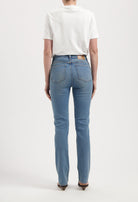 Classic straight-cut blue jeans with a white cotton t-shirt, showcasing back view of denim detailing and slim fit.