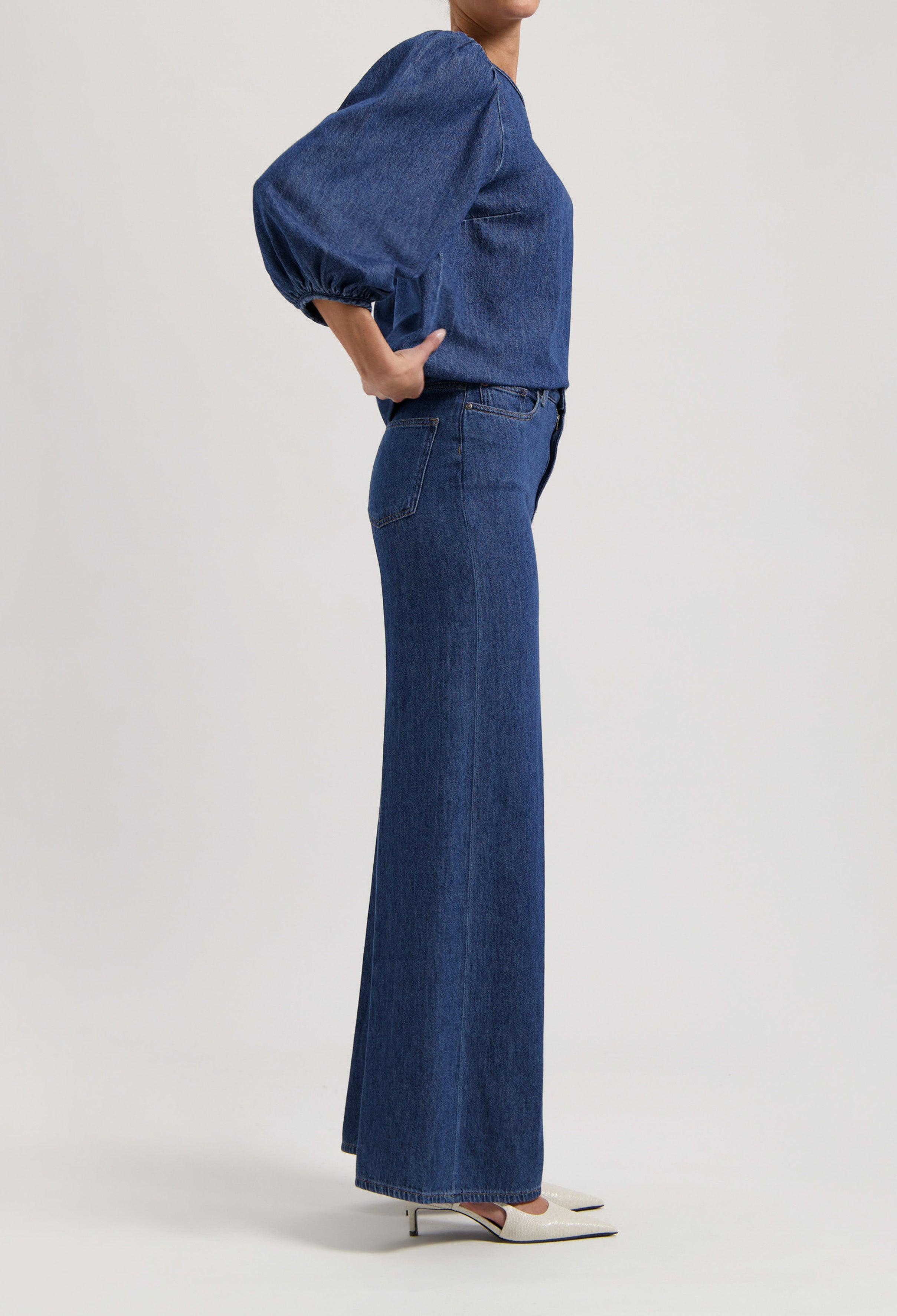 Fashion-forward wide-leg jeans in classic blue denim paired with a matching puff-sleeve top for a cohesive look.